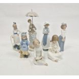 Seven Nao figures including lady with parasol and various children (7)