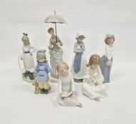 Seven Nao figures including lady with parasol and various children (7)