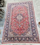 Central Persian red ground carpet with large central floral medallion on floral field, floral