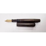 Swan fountain pen with a 14ct gold nib, marked 'Swan', within a mottled bakelite case