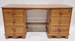 Pine kneehole dressing table having six drawers to the pedestals with turned bun handles, 72cm