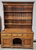 18th century oak dresser, the moulded cornice above three shelves and four spice drawers, the
