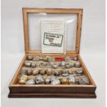 Collection of tea infusers, mainly stainless steel, from the 20th century, in a fitted box