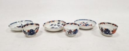 Three matched Japanese Imari pattern tea bowls and saucers, each with decoration depicting pagodas