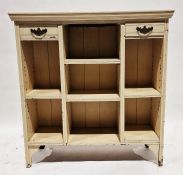 Cream painted bookcase having an arrangement of shelves and two short drawers with drop handles,