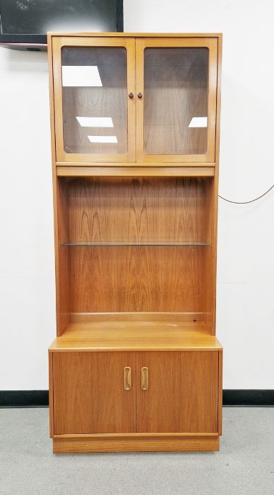 G-Plan teak unit with glazed cupboard to upper section, on base with three drawers with curved bar