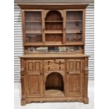 Large distressed pine dresser, the raised back with central arch over two shelves, flanked by pair