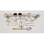 Assorted silver napkin rings, teaspoons, sugar nips, etc