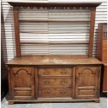 Antique oak dresser, the open plate rack with dentil and shaped cornice, fluted uprights, the base