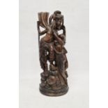 Eastern hardwood carving showing a female figure leaning towards a male figure, 50cm high