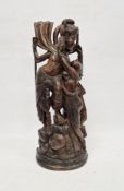 Eastern hardwood carving showing a female figure leaning towards a male figure, 50cm high