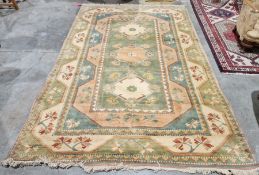 Modern green ground wool pile carpet with three central floral pattern lozenge medallion, multiple