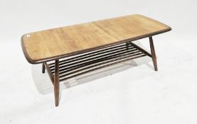 Ercol dark and light stained wood coffee table with rounded corners, having rail undershelf, 36cm