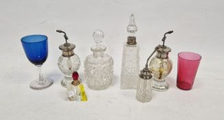 Three Victorian cut glass atomisers with silver coloured metal tops, two small cut glass scent