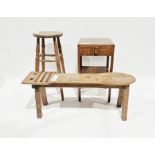 Stained wood cobbler's bench with shaped oval end and slats, a stained wood stool and a stained wood