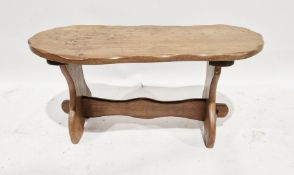 Late 20th century oak rustic oval shaped coffee table by F.E. Howard united by stretchers, 46cm high