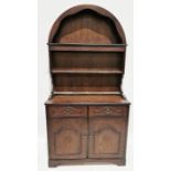 Stained oak dresser with arched top, three shelves, the base with two drawers and cupboards with