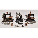 Collection of four early 20th century child's sewing machines, tinplate and cast iron, black with