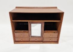 Stained wood cabinet, table-top, with shelves, central cupboard with mirrored door, small drawers