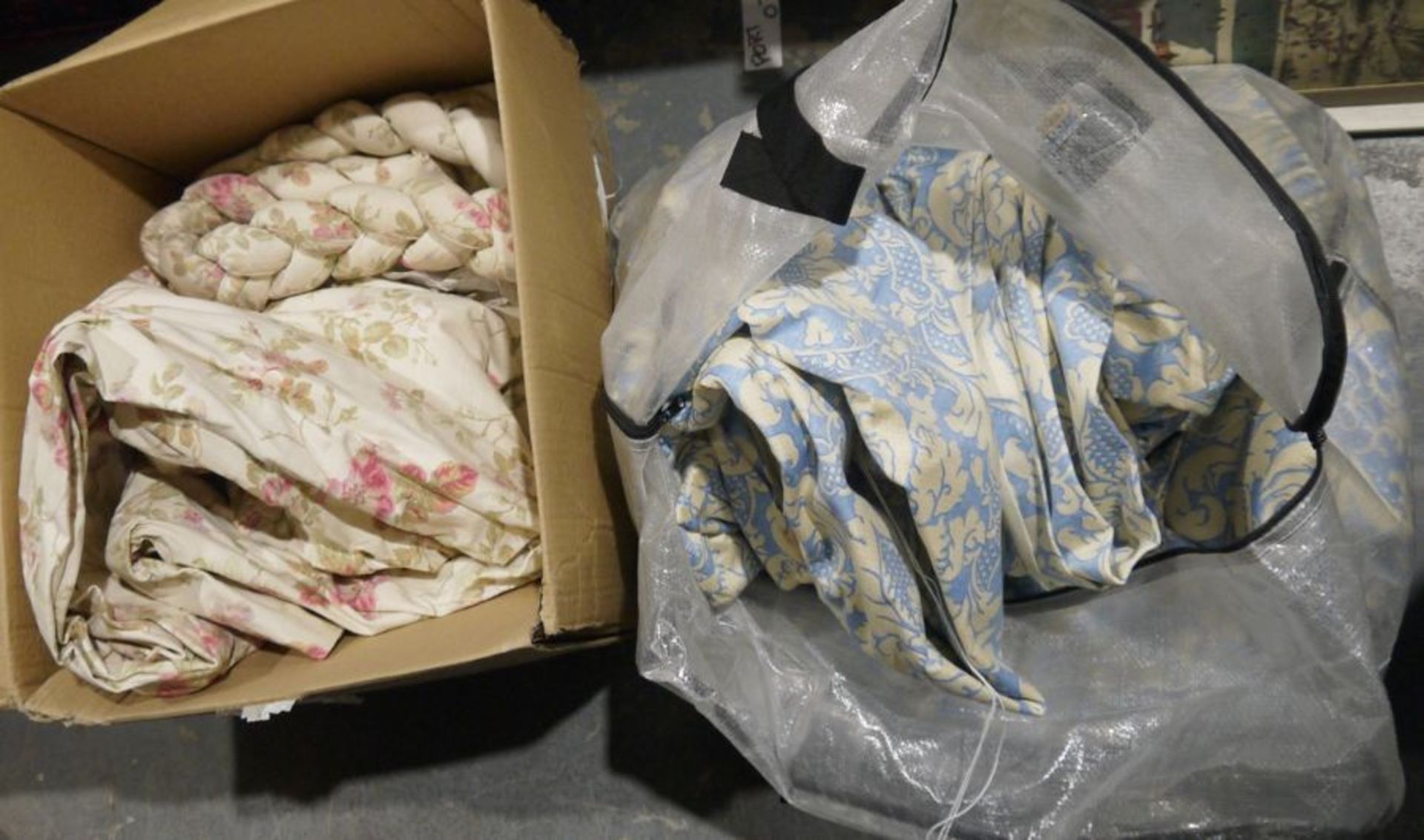 Pair of floral patterned cream ground curtains and two pairs of blue and cream floral patterned