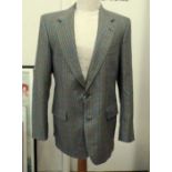 A vintage tweed suit, labelled Cecil G., a three piece black suit to include waistcoat, Hardy