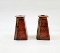 Pair of late 20th century copper, enamel and wooden-mounted candlestick holders, in orange, 11cm