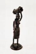 Bronze figure of an African woman carrying wood on her head, unsigned, 26cm high