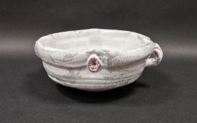 Pat Fuller (Contemporary) a white glazed fruit bowl with ropetwist handles, impressed mark to