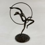 Bronze dancing figure with hoop on circular base, unsigned, 20.5cm high approx.