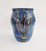 Large studio pottery vase of baluster form decorated with oxide stylised floral motifs on a blue