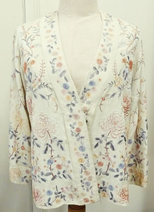 A 1920's silk jacket, embroidered in the Chinese style, cuffed sleeves, single button fastening,