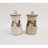 Pair of studio pottery stoneware lidded storage jars, brushwork floral motifs on speckled oatmeal