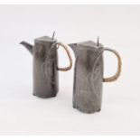 Pair of Art Nouveau pewter jugs with handles, relief decorated, 22cm high each approx. (2)