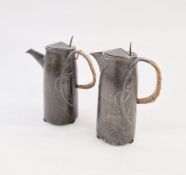 Pair of Art Nouveau pewter jugs with handles, relief decorated, 22cm high each approx. (2)