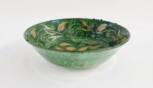 Tito Ubeda studio pottery bowl, sgraffito decorated with leaves on a green ground, incised 'Tito