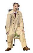 A fibreglass life-size mannequin/model of a seated gentleman, wearing a driving duster coat, goggles