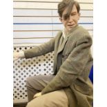 A fibreglass life-size mannequin/model of a seated gentleman in vintage costume, believed to have