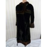 A black moleskin and mink vintage coat, labelled Neustadter, the square fold over collar, the