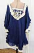 A blue cotton dress angel sleeves, the cuffs and bodice decorated with ethnic tassels and braiding