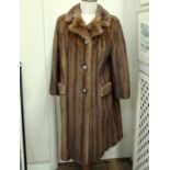 A full length mink coat, front pockets, horn button fastening