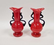 Pair of Bohemian red glass 'Tango' vases with blue handles, 21.5cm high