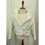 A short white coney jacket with bobble and hook fastening, cashier's name tape in lining, full