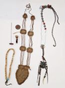 A metal chatelaine decorated with Japanese symbols, turquoise and other beads, a hatpin, beaded