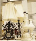 Wrought iron table lamp with clock, another wrought iron table lamp, an alabaster lamp, a marble