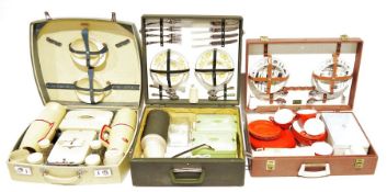 Three mid 20th century cased picnic sets, all three nearly complete (3)
