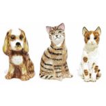 Two ceramic models of seated cats and a spaniel-type dog (3)
