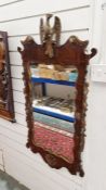 Mahogany fretwork mirror with eagle relief and gilt highlights, 100cm x 55cm approx.