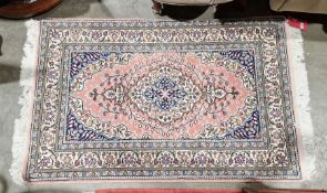 Turkish wool pink ground rug with floral medallion, floral spandrels and multiple floral borders