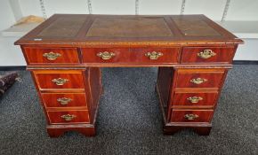 Modern pedestal desk with brown leather inset top, an arrangement of drawers around the kneehole,