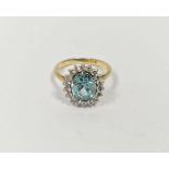 18ct gold yellow gold, diamond and blue stone ring, the oval central stone aquamarine in colour